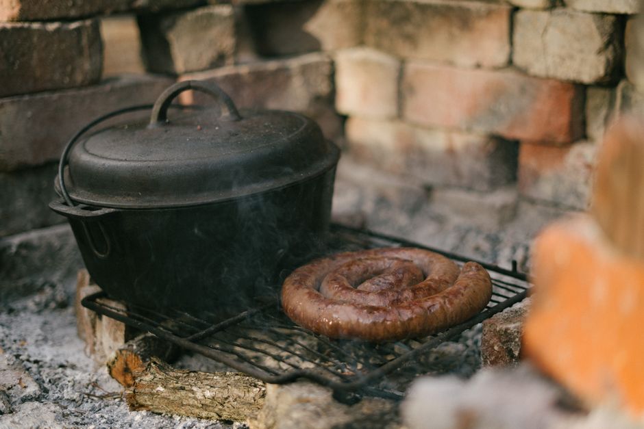 Cast Iron Pan Smoking: Causes and How to Fix It Well-seasoned cast iron pan smoking over stovetop burner in warm kitchen light